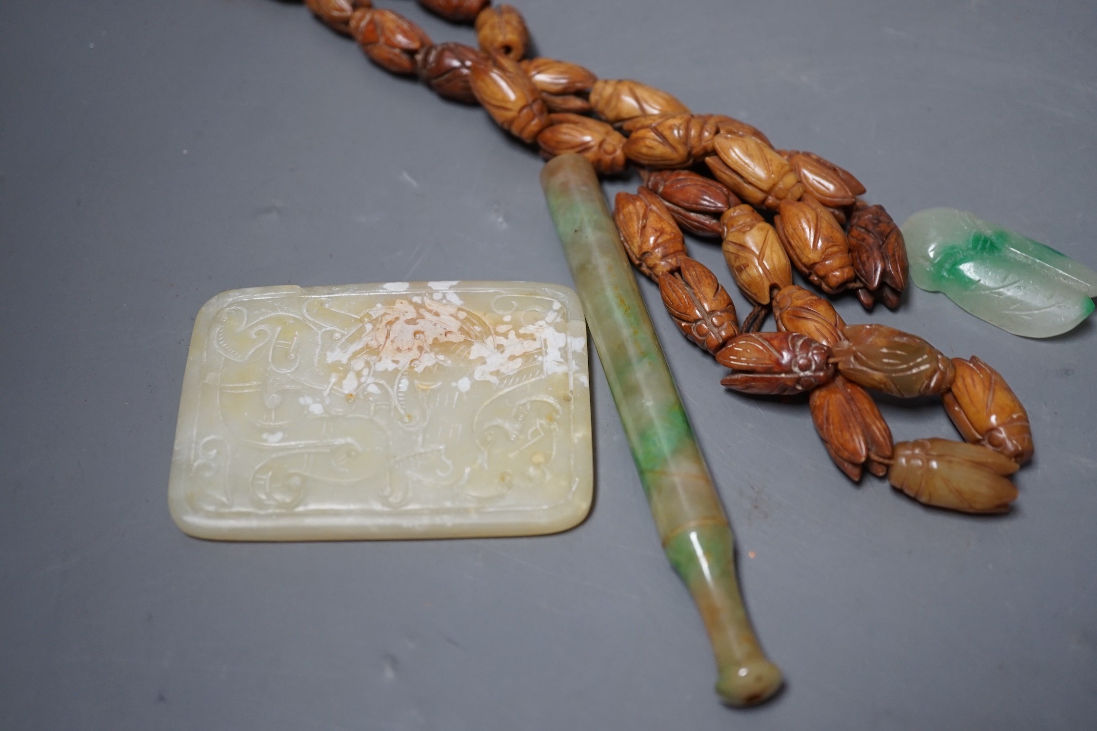 Chinese carved Hardstone ‘cicada’ bead necklace, a carved hardstone plaque a jadeite pipe mouthpiece and similar cicada